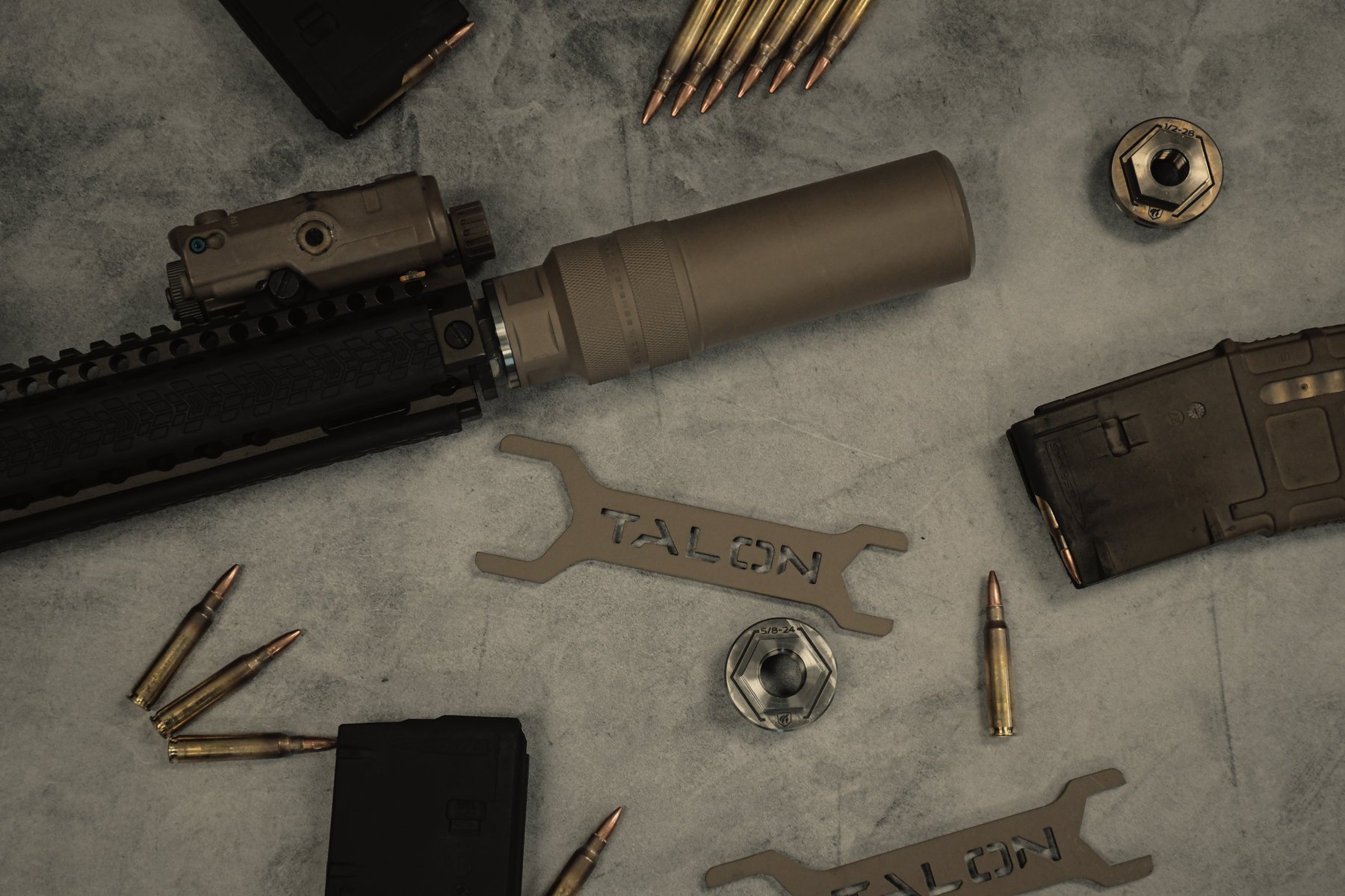 Diode-equipped rifle laid out with the Talon wrench, both thread adapters, magazines and brass