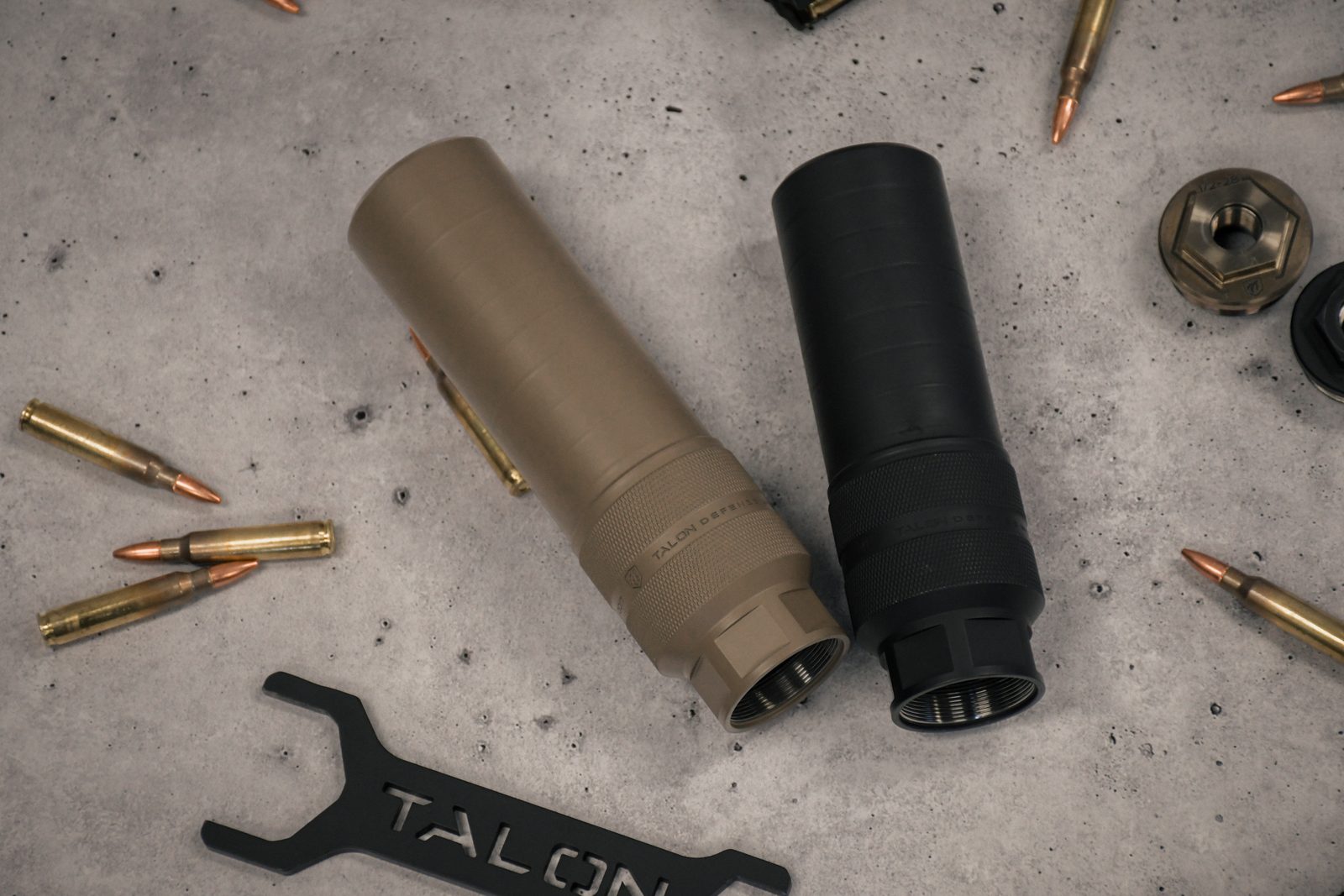 Three Talon development cans: raw welded stainless, FDE Cerakote, and production black