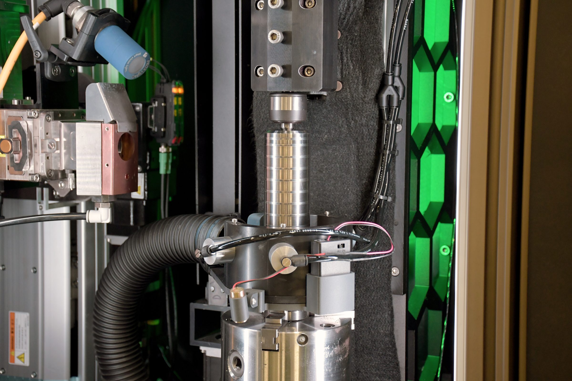 Laser weld cell with a suppressor tube fixtured under the head