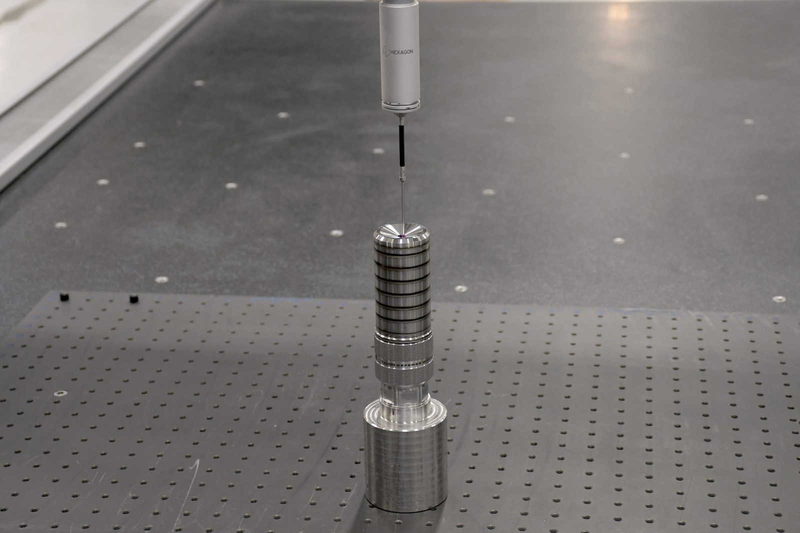CMM ruby probe checking the bore of a suppressor tube in a V-block