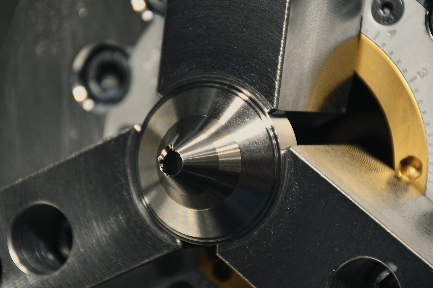 Collet chuck on the CNC lathe holding a turned stainless tube, tool bar coming in