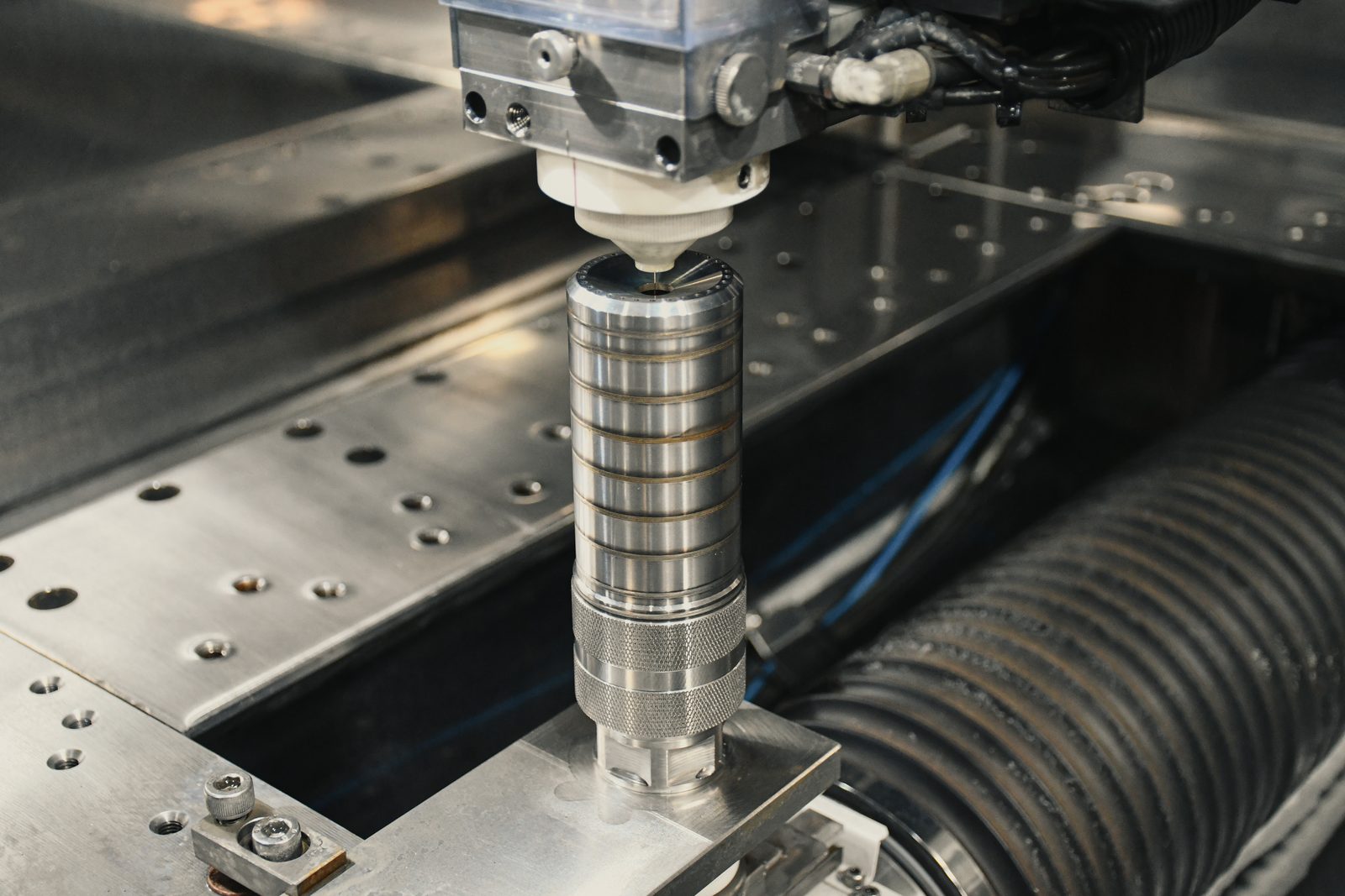 Wire EDM wire guide over a suppressor tube standing in the fixture